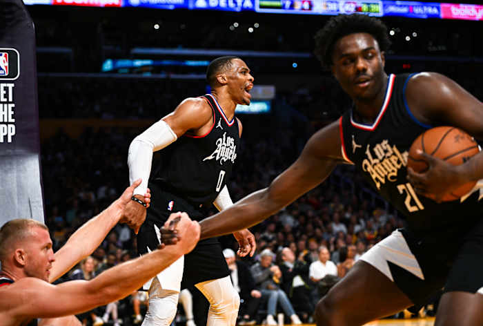 Nov 1, 2023; Los Angeles, California, USA; LA Clippers guard Russell Westbrook (0) and guard Kobe Brown (21) help up teammate center Mason Plumlee (44) against the Los Angeles Lakers during the second quarter at Crypto.com Arena.
